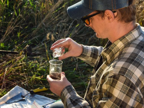 Photo of a man testing his soil