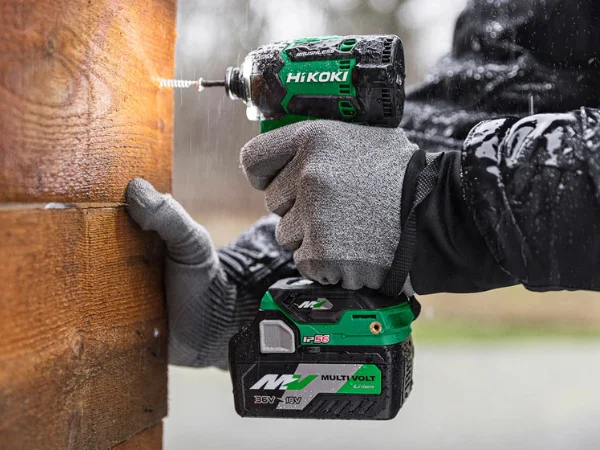 HiKOKI WH36DC Triple Hammer driving a screw outdoors in wet conditions.