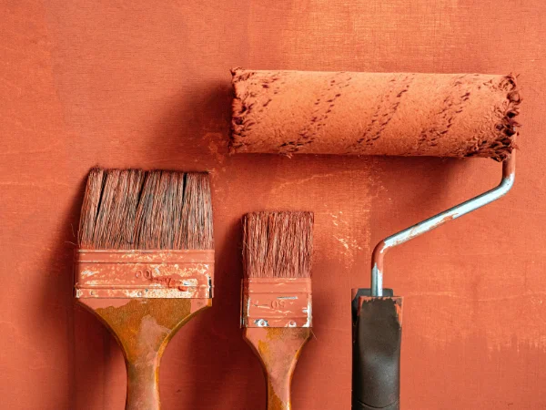 Paint brushes and roller kept moist between coats to prevent drying during a project. just like this image has.