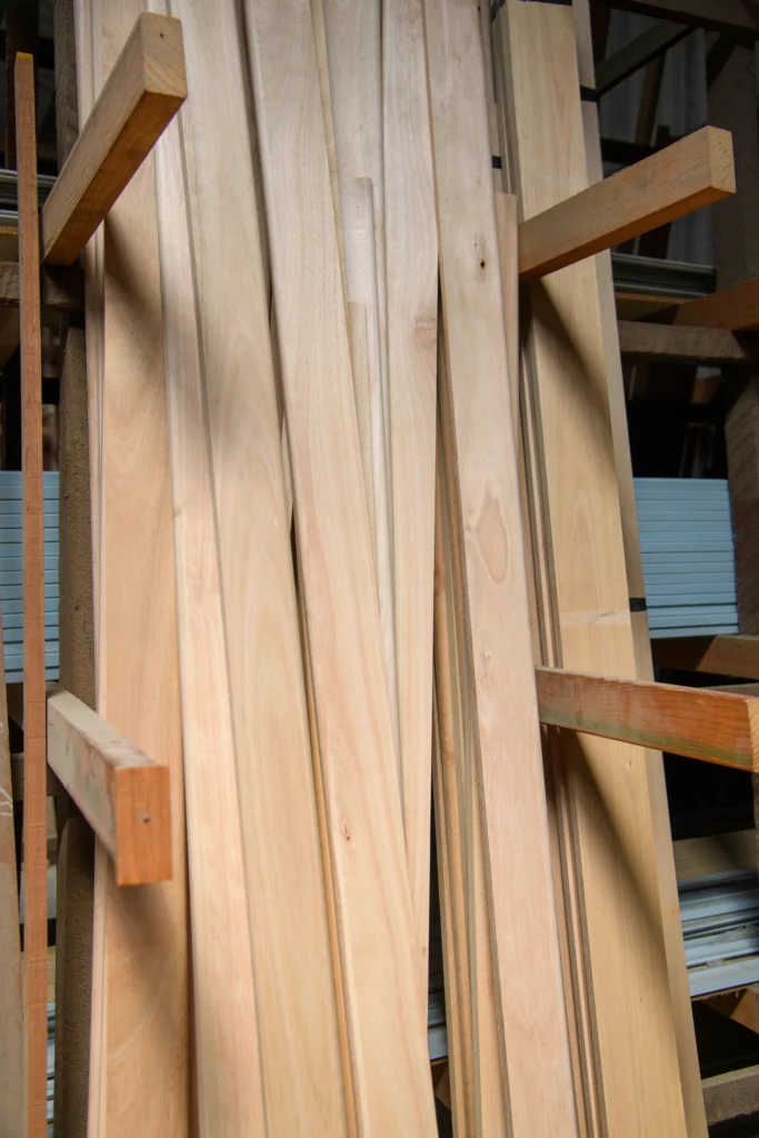 Stack of Western Light Blue Gum timber planks neatly arranged in a timber yard, showcasing the clean, light-coloured grain and smooth surface of the wood.