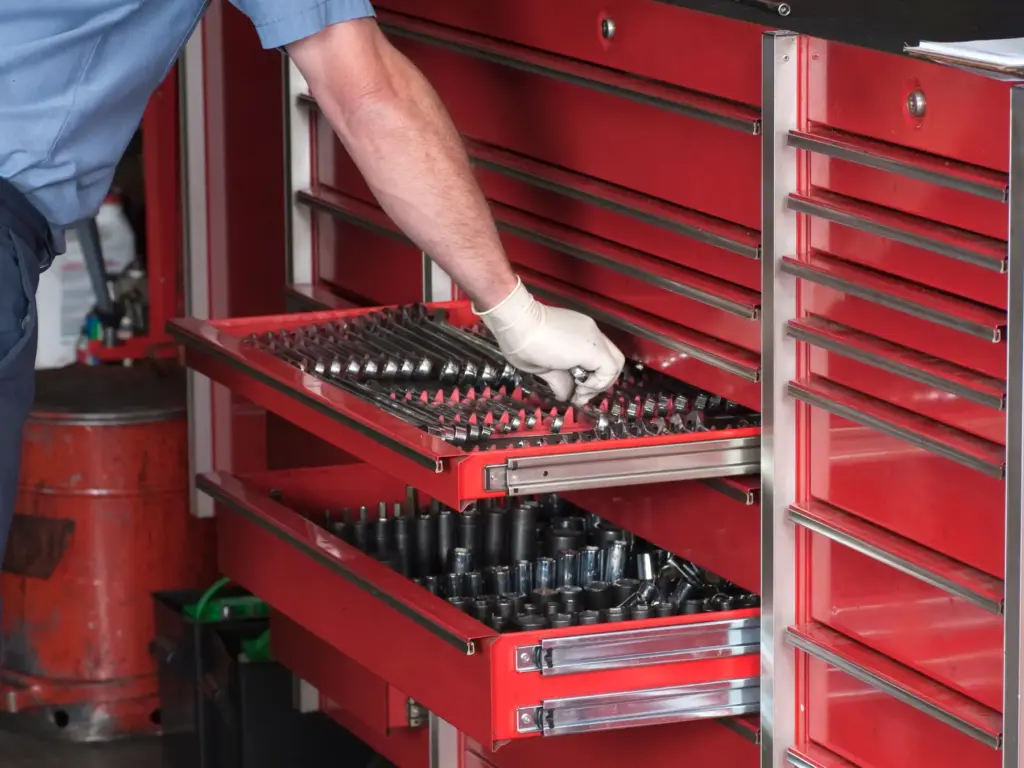 Tradesperson storing tools in a dry toolbox drawer to stop rust before it starts.